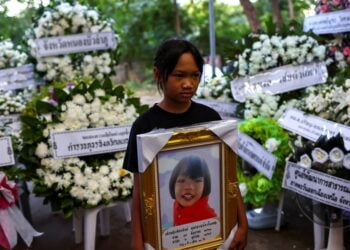 Prayers, sorrow at temples as Thailand mourns children slain in massacre