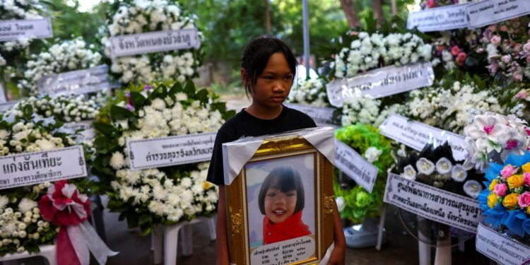Prayers, sorrow at temples as Thailand mourns children slain in massacre